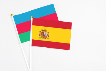 Spain and Azerbaijan stick flags on white background. High quality fabric, miniature national flag. Peaceful global concept.White floor for copy space.
