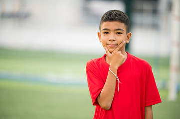 Boy playing football on the football practice field