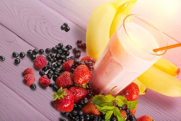Tasty banana milkshake on wooden table top view