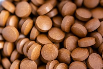 Brown iron supplement pills in the hands