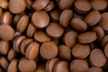 Brown iron supplement pills in the hands