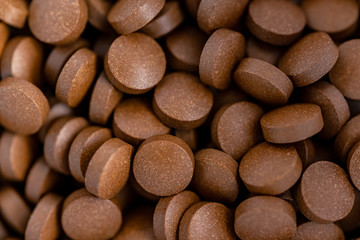 Brown iron supplement pills in the hands