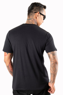 Sixpack man with tattoo wearing black t-shirt short sleeve in back side view isolated on white background