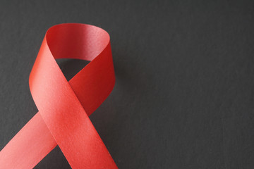 Red ribbon on a black background. World Aids Day concept