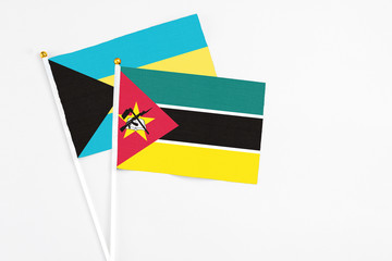 Mozambique and Bahamas stick flags on white background. High quality fabric, miniature national...
