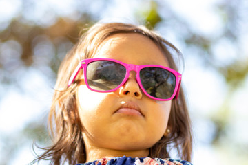 Cute little girl with pink sunglasses