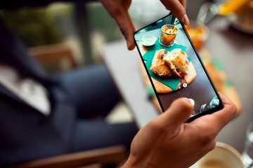 Man using phone to make picture of food