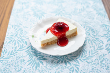 Slice of plain cheesecake with strawberry cheese cake