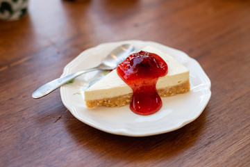 Slice of plain cheesecake with strawberry cheese cake