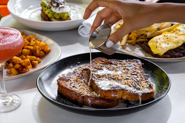 Lunch appetizer - toasts from brown bread with sauces and spices outside restaurant interior