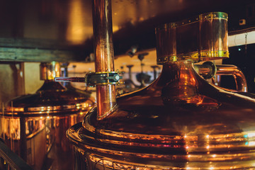 Craft beer brewing equipment in brewery Metal tanks, alcoholic drink production.