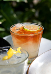 Fresh alcohol cocktail or lemonade beverage outside of restaurant in a summer day