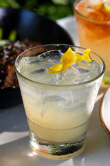 Fresh alcohol cocktail or lemonade beverage outside of restaurant in a summer day