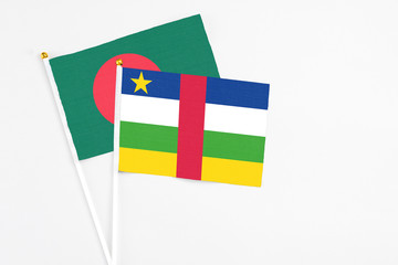 Central African Republic and Bangladesh stick flags on white background. High quality fabric, miniature national flag. Peaceful global concept.White floor for copy space.