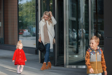 Fototapeta premium Mother with two children at the entrance.