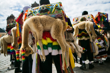 Costumed dancers at a celebration of Cruz Velacuy in Cusco, Peru. - obrazy, fototapety, plakaty