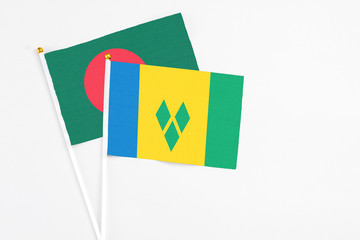 Saint Vincent And The Grenadines and Bangladesh stick flags on white background. High quality...