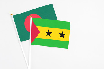 Sao Tome And Principe and Bangladesh stick flags on white background. High quality fabric, miniature national flag. Peaceful global concept.White floor for copy space.