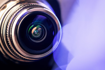 The camera lens with purple backlight. Optics. Gorizontal photo