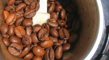 coffee grinder with roasted coffee beans.Whole coffee beans in a coffee grinder