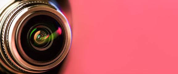.Banner. The camera lens with red and pink backlight. Optics. .