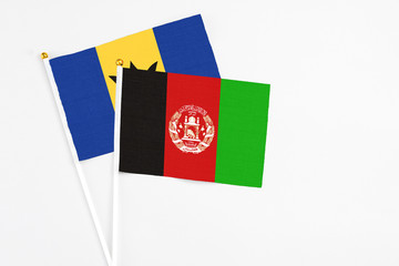 Afghanistan and Barbados stick flags on white background. High quality fabric, miniature national flag. Peaceful global concept.White floor for copy space.