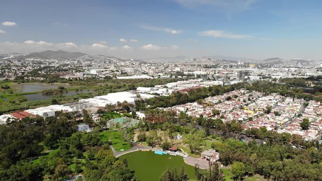 Aerial view of Parque Tezozomoc in Mexico City. Drone flying backwards.