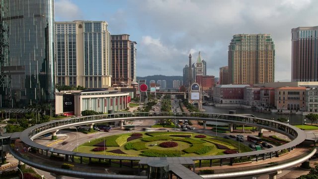 Timelapse cars drive under famous Rotunda do Istmo pedestrian bridge in Cotai Macau New Urban Zone with modern buildings and flashing advertisements in China