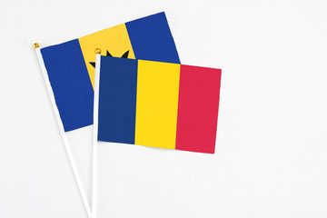 Chad and Barbados stick flags on white background. High quality fabric, miniature national flag. Peaceful global concept.White floor for copy space.