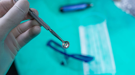 Dental metal tool in the hand.