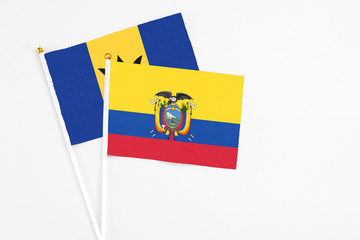 Ecuador and Barbados stick flags on white background. High quality fabric, miniature national flag. Peaceful global concept.White floor for copy space.