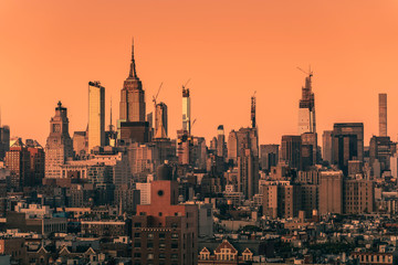 Fototapeta na wymiar Sunset above Manhattan skyscrapers, New York City. Light effect applied