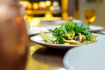 Italian food - Calamari garlic topped with rocket leaves in selective focus