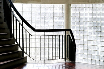 Staircase handrail near  translucent cubic wall