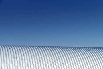 abstract of metallic roof under blue sky