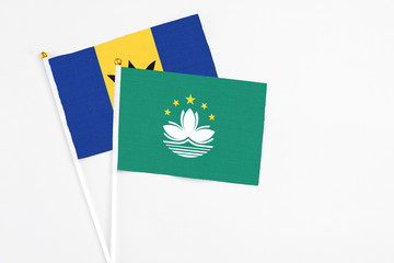 Macao and Barbados stick flags on white background. High quality fabric, miniature national flag. Peaceful global concept.White floor for copy space.