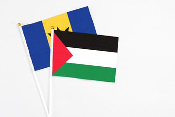 Palestine and Barbados stick flags on white background. High quality fabric, miniature national...