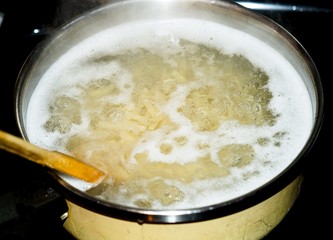Macaroni boiling in a pot of water 