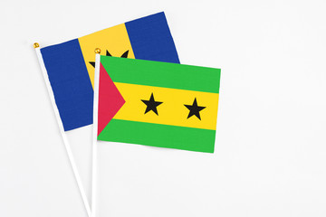 Sao Tome And Principe and Barbados stick flags on white background. High quality fabric, miniature national flag. Peaceful global concept.White floor for copy space.