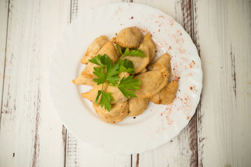 fried dumplings with spices on a plate - 302363270