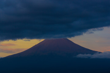 Fototapeta premium Popocatepetl active volcano, blue sunrise clouds on top