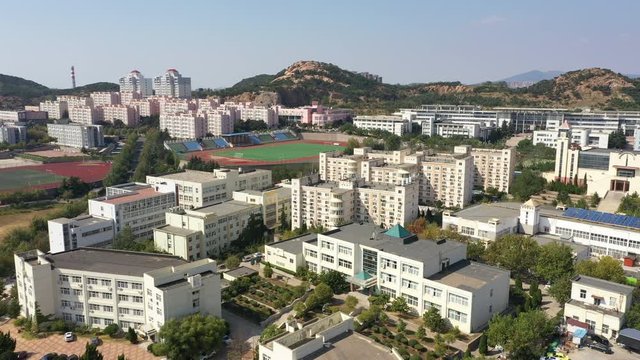 Flying over campus buildings of Qingdao University of Science and Technology, academics and education in China