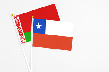 Chile and Belarus stick flags on white background. High quality fabric, miniature national flag. Peaceful global concept.White floor for copy space.