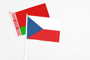 Czech Republic and Belarus stick flags on white background. High quality fabric, miniature national flag. Peaceful global concept.White floor for copy space.