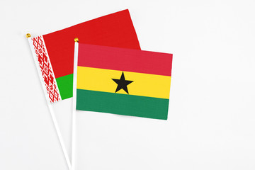 Ghana and Belarus stick flags on white background. High quality fabric, miniature national flag. Peaceful global concept.White floor for copy space.