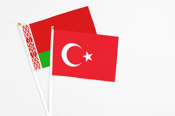 Turkey and Belarus stick flags on white background. High quality fabric, miniature national flag. Peaceful global concept.White floor for copy space.