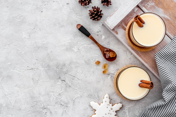 Eggnog - cute New Year composition with alcoholic drink on grey background top view frame copy space