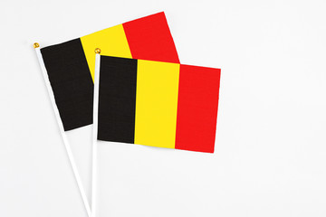 Belgium and Belgium stick flags on white background. High quality fabric, miniature national flag. Peaceful global concept.White floor for copy space.