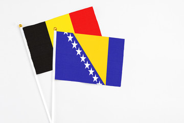 Bosnia Herzegovina and Belgium stick flags on white background. High quality fabric, miniature...