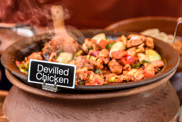 Devilled Chicken is for sale, served from  a warm clay pot at a street vendors stall